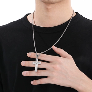 Silver stainless steel double cross pendant necklace worn by a model on black t-shirt