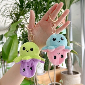 Detailed close-up of reversible octopus plush keychain with high-quality gold metal clips