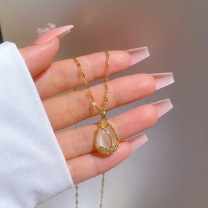 Elegant gold tulip necklace with white cat eye stone and micro-pave cubic zirconia pendant