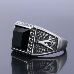 Detail of vintage Masonic ring with black gemstone and engraved AG symbol on silver band