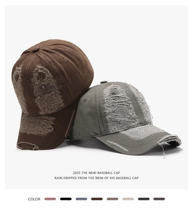 Detailed view of distressed baseball caps with heavy frayed edges and vintage washed finish