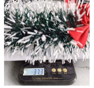 Detail showing the light weight of the green and white Christmas garland on a digital scale