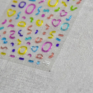 Macro detail of 3D epoxy jelly nail stickers featuring colorful 3D geometric shapes