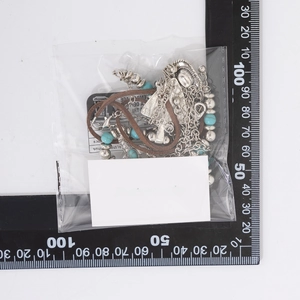 Detail view of retro turquoise beads and bull head pendant necklace in packaging