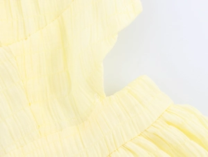 Detail shot of pale yellow textured bubble fabric with fine stitching for summer dress