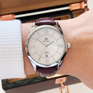 Detail of silver quartz watch with white Roman dial and brown crocodile leather strap