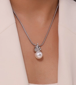 Close-up of silver rabbit pendant with pearl on a snake chain necklace for women