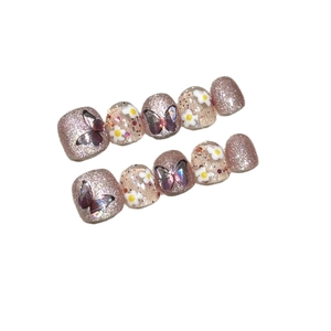 Press-on toenails for kids featuring butterfly designs, pink glitter, and floral patterns