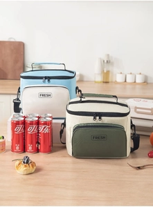 Insulated lunch bags with front zipper pocket, carrying handles and adjustable shoulder strap