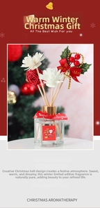 Detailed Christmas reed diffuser set with red berries and bell in a glass bottle