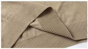 Close-up of beige knit fabric texture and ribbed hem detail on slim fit sweater