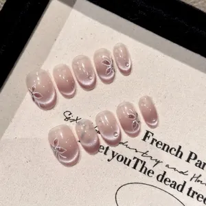 Handmade soft pink cat-eye press-on nails with 3D water drops and flower patterns