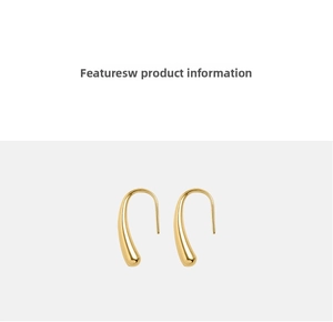 Macro shot of polished gold-toned teardrop earrings with a sleek high-gloss mirror finish