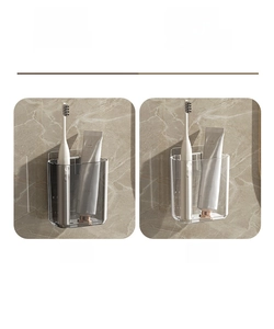Detail of wall-mounted transparent and grey bathroom organizers for toothbrushes