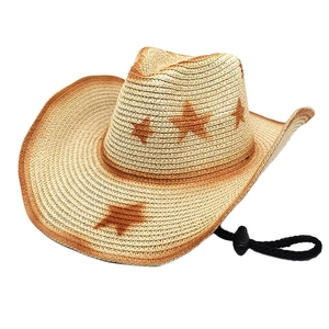Detail of woven cowboy straw hat featuring star patterns and adjustable chin strap
