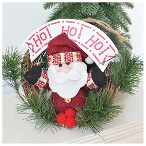 Detail of Christmas wreath with Santa Claus, pine needles and HO HO HO wooden sign