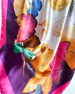 Close-up of colorful ginkgo leaf print on premium satin scarf with silky texture