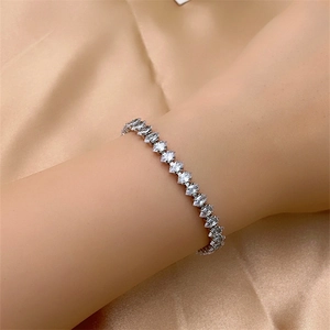 Detailed view of silver marquise-cut cubic zirconia bracelet on premium silk fabric