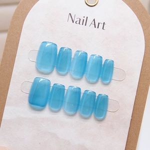 Blue cat eye press-on nails in square shape on a kraft display card