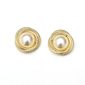 Macro detail of Baroque pearl earring with elegant golden twisted rope metal frame