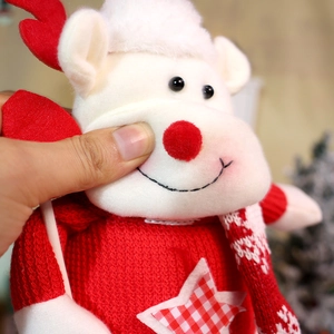 Detail shot of soft knit plush texture and checkered star on Christmas doll