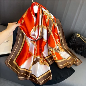 Elegant silk-like scarf with orange chain and rope patterns, large satin beach shawl