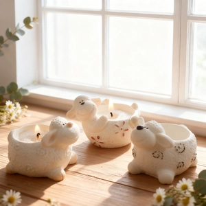 Three-piece set of sheep-shaped candle holders with detailed embossed wool texture
