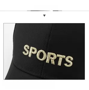 Close-up of golden 3D SPORTS embroidery on black breathable cotton baseball cap