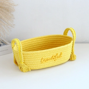 Detailed texture of yellow hand-woven cotton rope storage basket with beautiful lettering