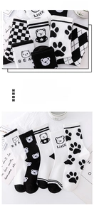 Detail of five pairs of cotton crew socks featuring black and white patterns and bear motifs