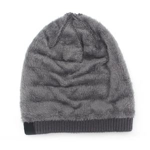 Detailed close-up of thick dark grey ribbed knit hat with soft faux fur lining for winter