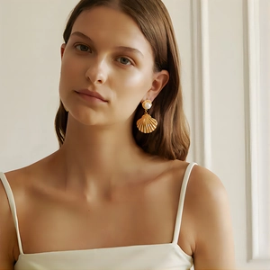 French style 18k gold plated shell earrings with pearls on model in white background