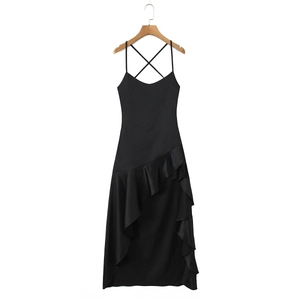 Detail of elegant black slip dress featuring ruffled hem and thin spaghetti straps