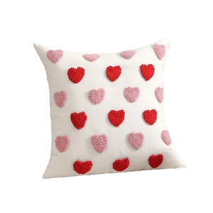White pillowcase featuring red and pink tufted heart patterns for Valentines decor