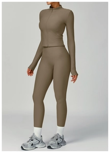 Detail of ribbed texture on a high-waisted slimming yoga set with a full zipper jacket