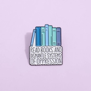Blue stacked books enamel pin with Read Books and Dismantle Systems of Oppression text