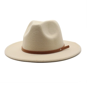 Detailed close-up of beige fedora hat with brown leather band and metal rivets