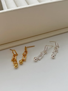 Macro shot of gold and silver S925 sterling silver horseshoe ball earrings set