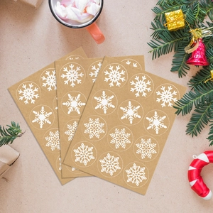 Close-up of kraft paper snowflake stickers for Christmas gift wrapping and DIY decor