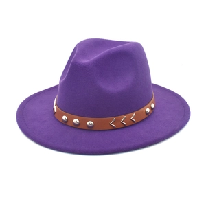 Detailed view of purple wool fedora hat featuring a brown leather band and metal studs