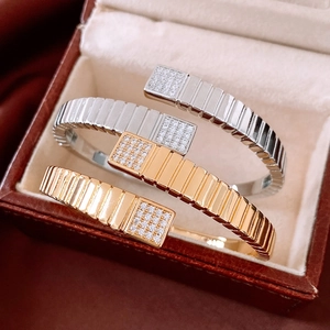 Detailed view of three Tubogas style bracelets with paved cubic zirconia ends in jewelry box