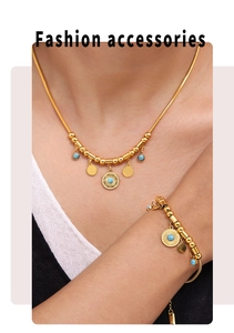 Detail of turquoise sun pendant necklace and bracelet set in 18k gold plated titanium steel