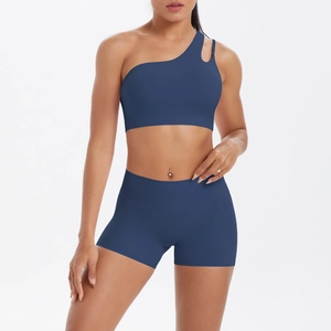 Detail of one-shoulder yoga bra with side cutout and matching high-waist shorts set