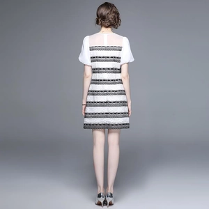 Elegant black and white contrast lace mini dress featuring short sleeves and back view