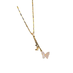 Elegant gold butterfly necklace with pink and clear crystals on a textured chain