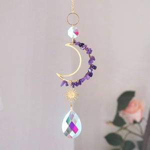 Detail of golden moon and sun suncatcher with purple amethyst and rainbow crystal prisms