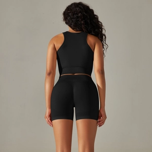 Back view of black seamless yoga set with racerback crop top and high waist shorts