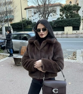 Close-up of brown faux fur short jacket featuring a large collar for autumn winter street style