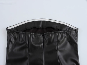 Detail view of black PU leather mini dress waist with invisible zipper and silicone grip tape