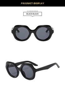 Detailed views of stylish oversized round black sunglasses with polished frames